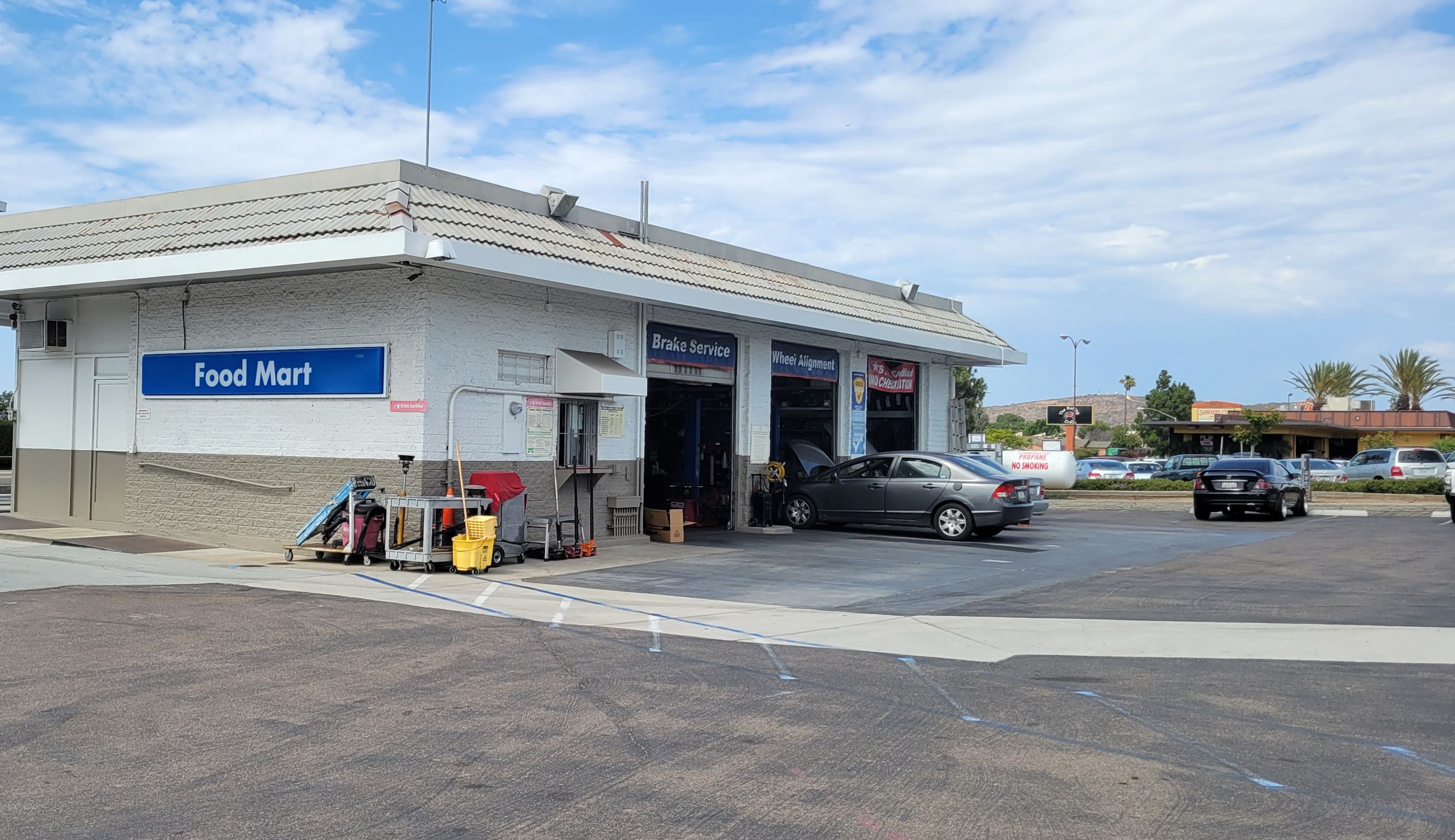 Mira Mesa Auto & Tire building with the service bays and Food Mart on Mira Mesa Blvd
